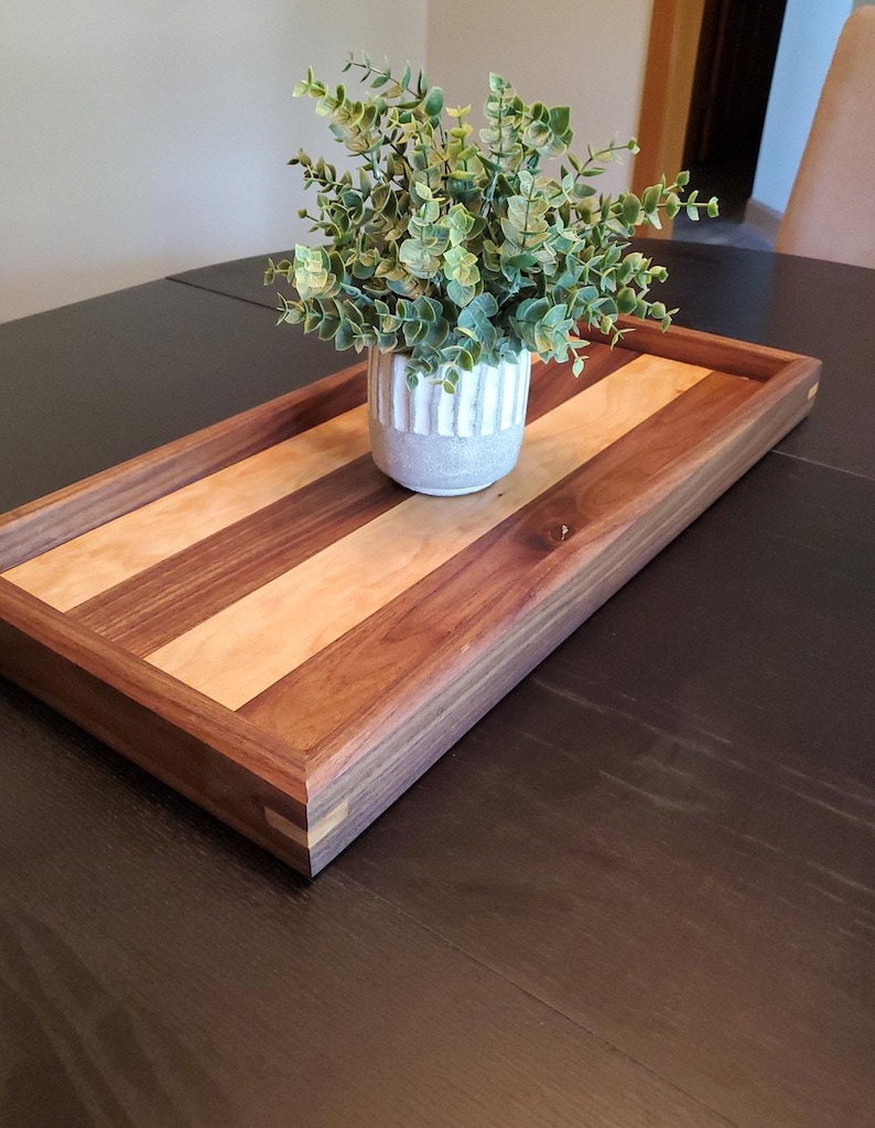 Long walnut and maple serving tray in a warm room