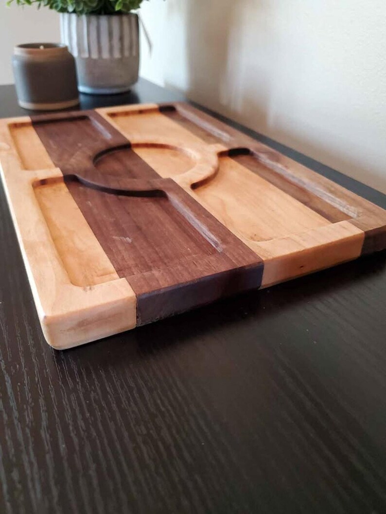 Close low-angle detail of the maple, walnut, and routed valet compartments